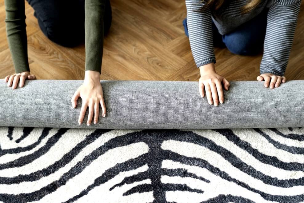 People rolling out carpet